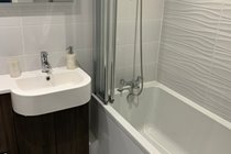Main bathroom with over-bath shower
