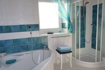 Bathroom with separate shower cubicle and bath with overhead shower