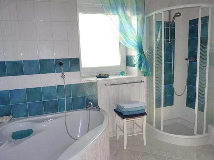 Bathroom with separate shower cubicle and bath with overhead shower