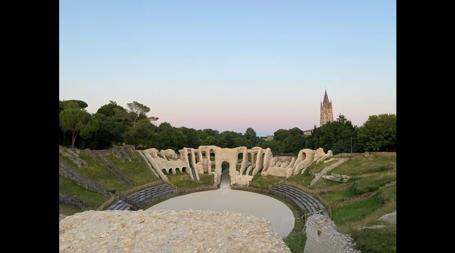 Explore the Roman Amphitheatre at Saintes, where a restoration project has commenced. Abbaye aux Dames stands tall in the background