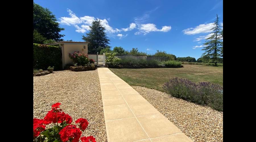 Garden path leads from the terrace to the private, sheltered, heated pool area in sunshine all day