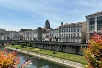 Saintes from the River Charente, where boats can be hired, with Cathèdrale Saint Pierre in the distance