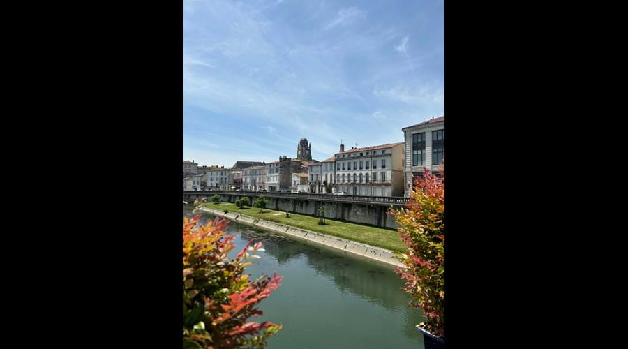 Saintes from the River Charente, where boats can be hired, with Cathèdrale Saint Pierre in the distance