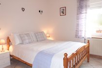 Downstairs double bedroom with wardrobe and chest of drawers