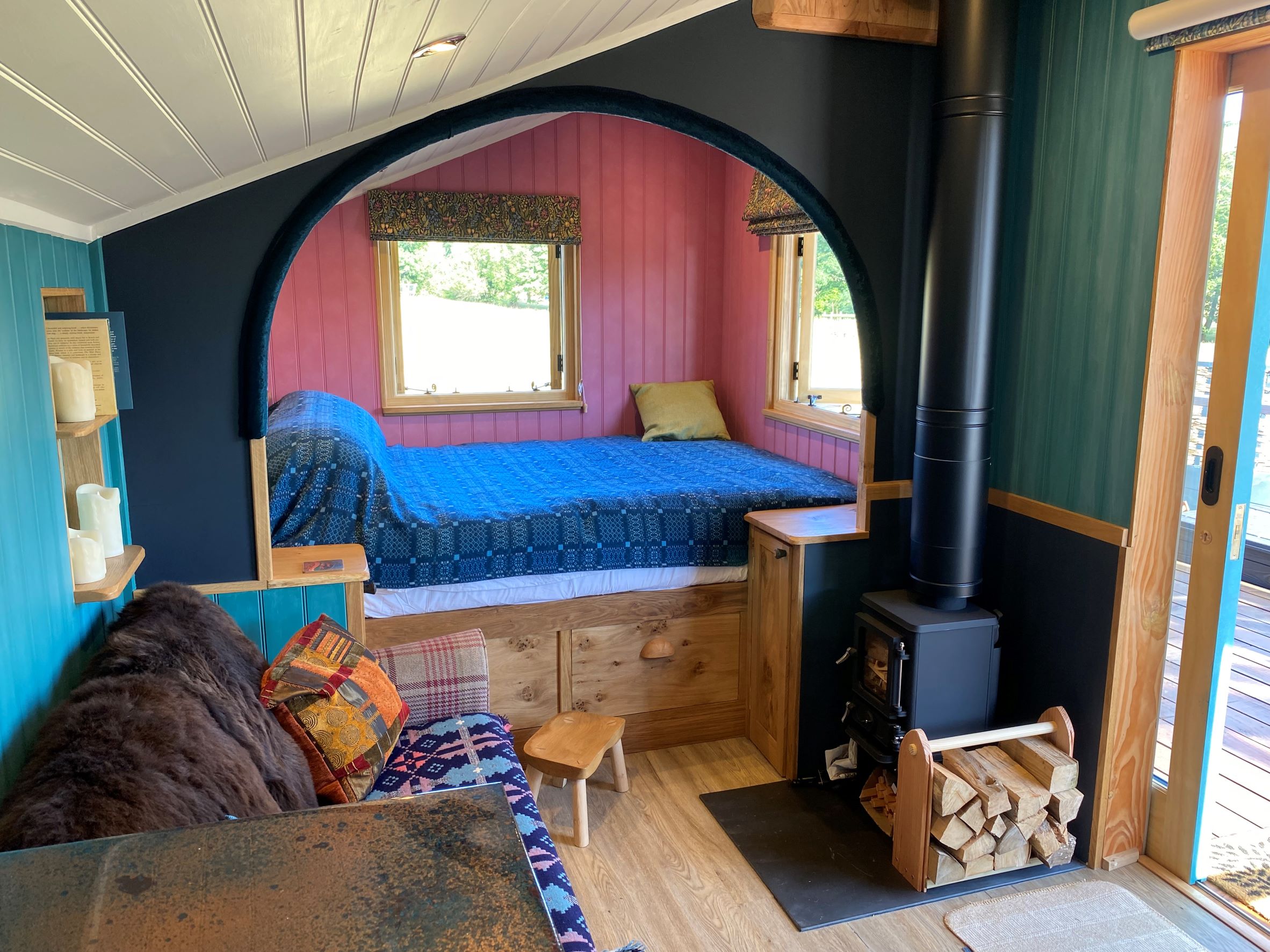 Bedroom end of cabin with wood burning stove