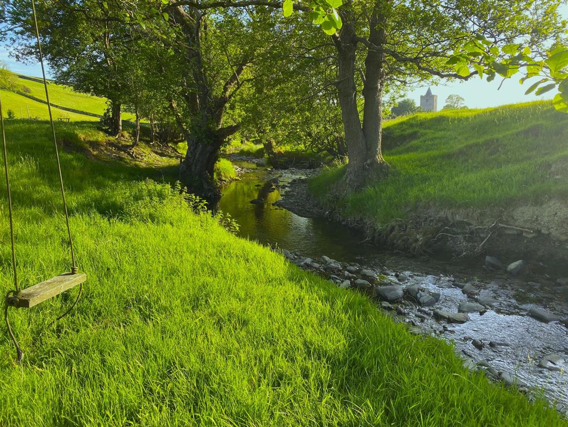 Eco glamping cabin. Swing by stream