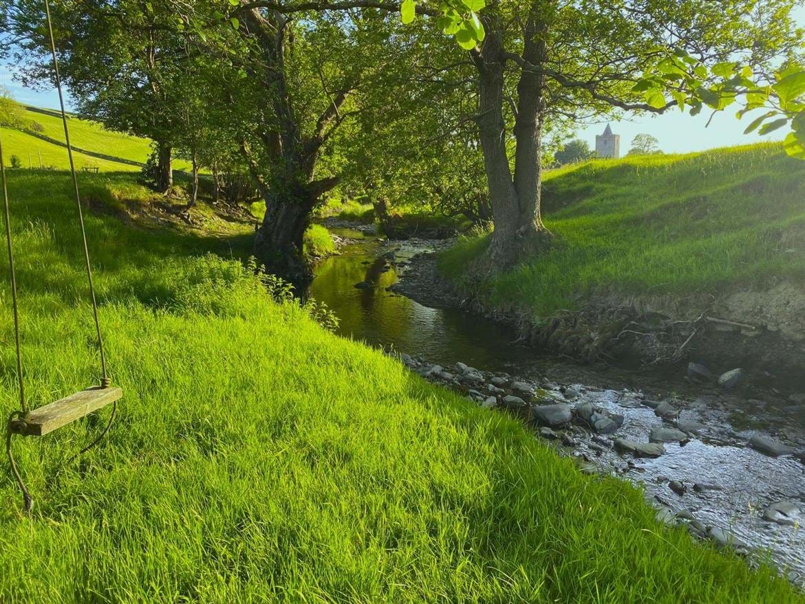 Eco glamping cabin. Swing by stream