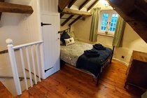 Cosy Bedroom with Stairs Showing