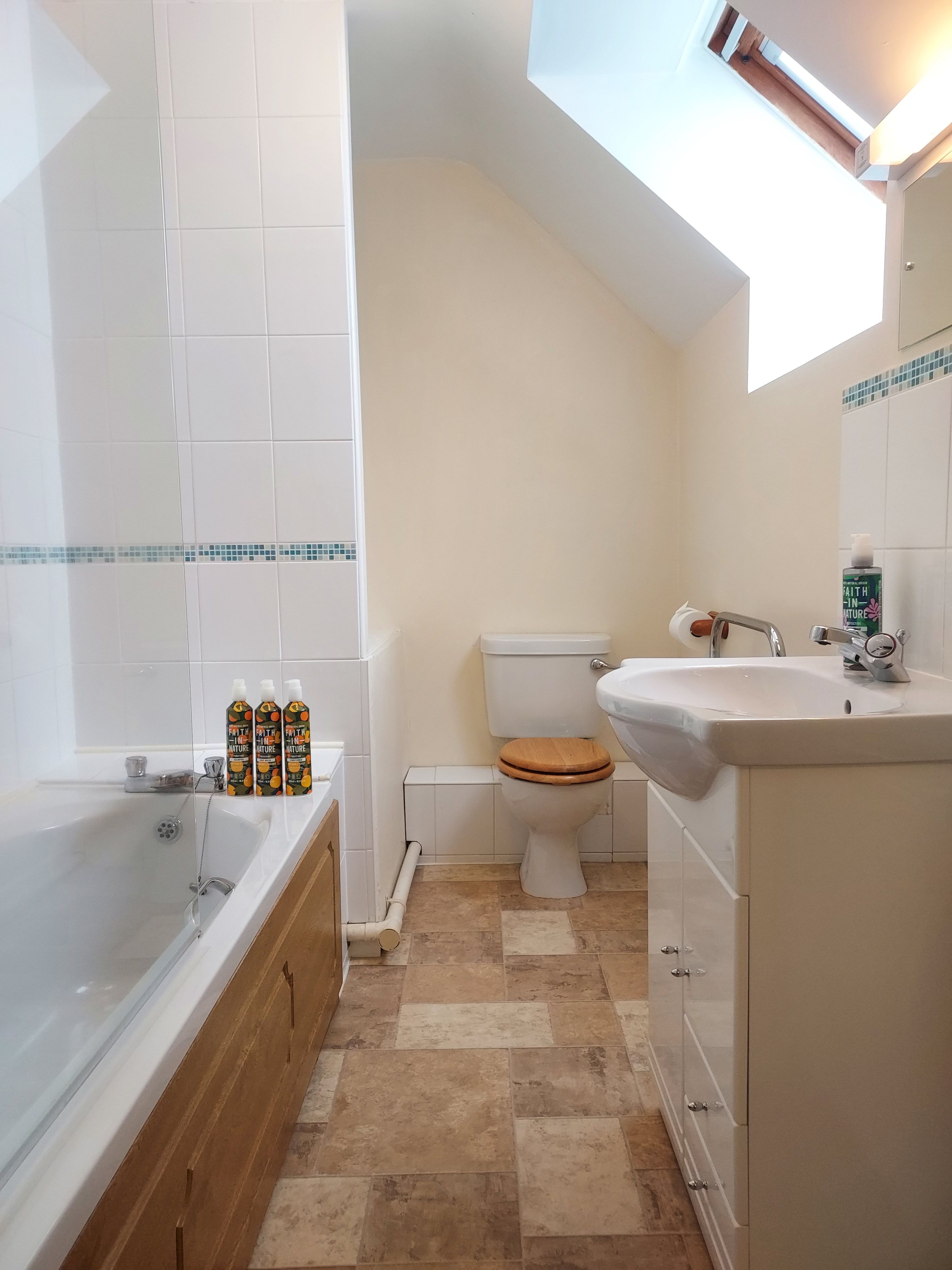 Family bathroom: bath with shower over