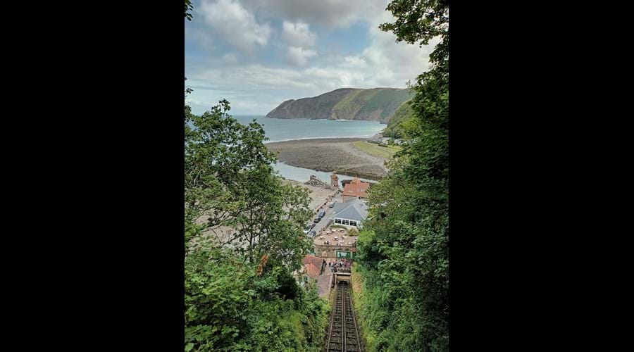 View of the tree lined cliff railway with the bay and cliffs in the distance