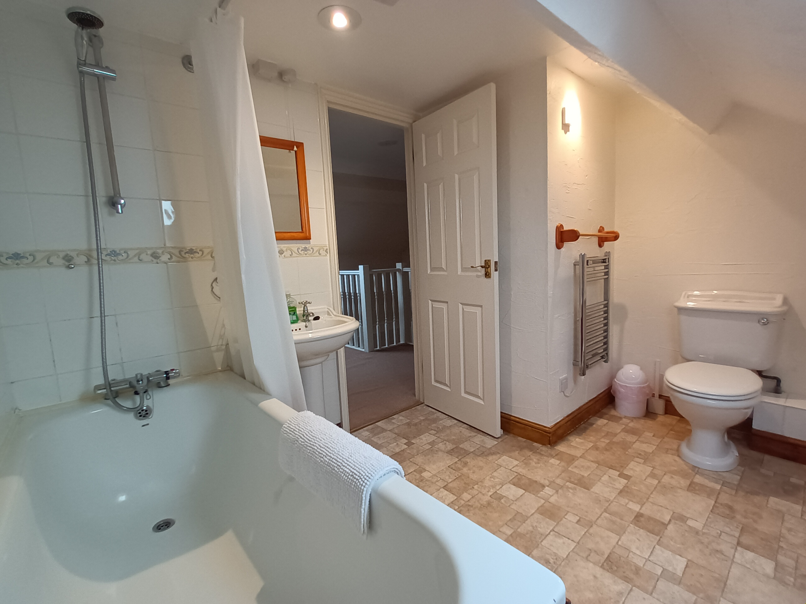 This first floor bathroom has a bath with shower over. Plenty of space for bathing the kids.