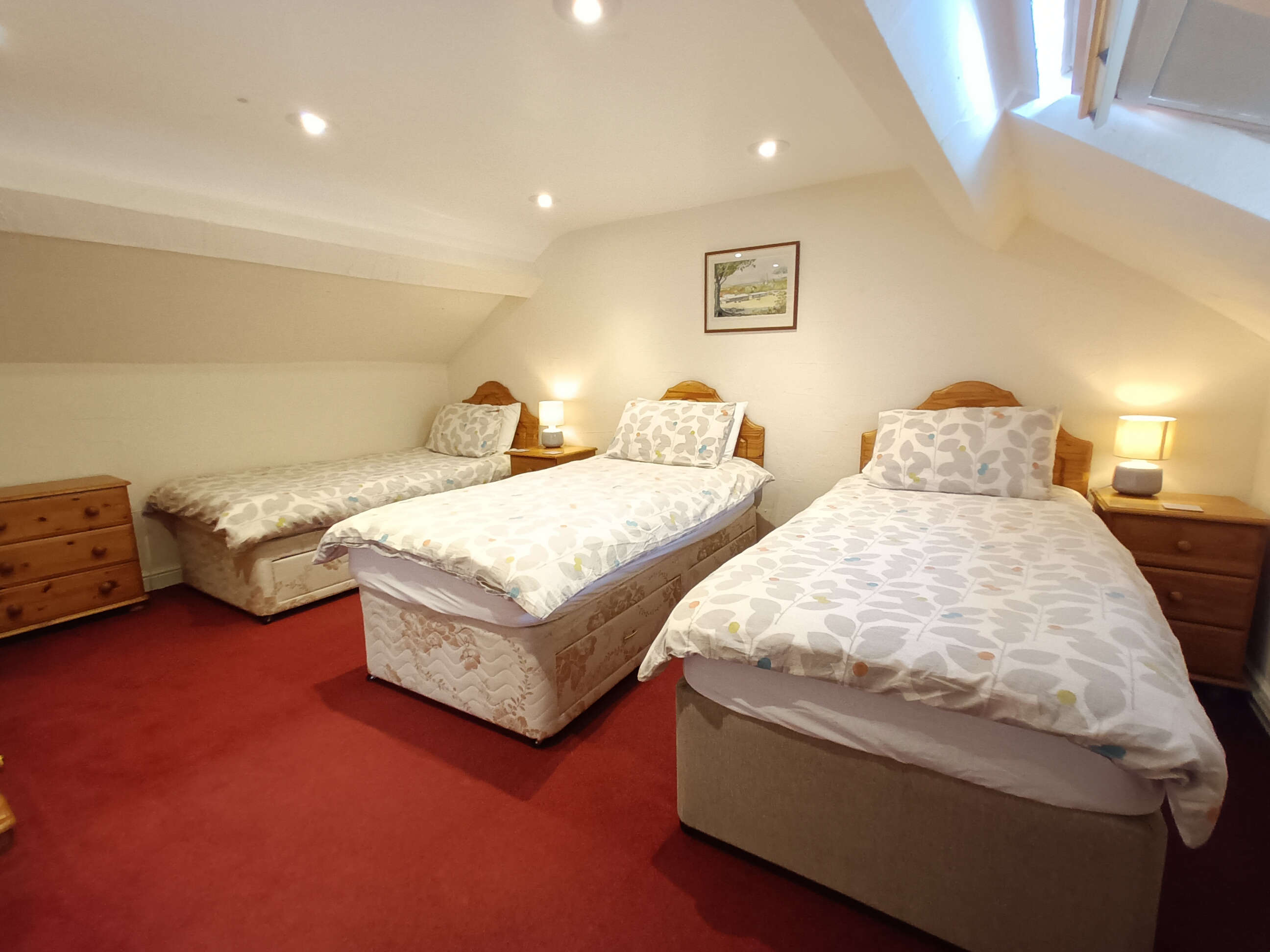 This first floor bedroom has three full size single beds, plenty of clothes storage and lots of natural light
