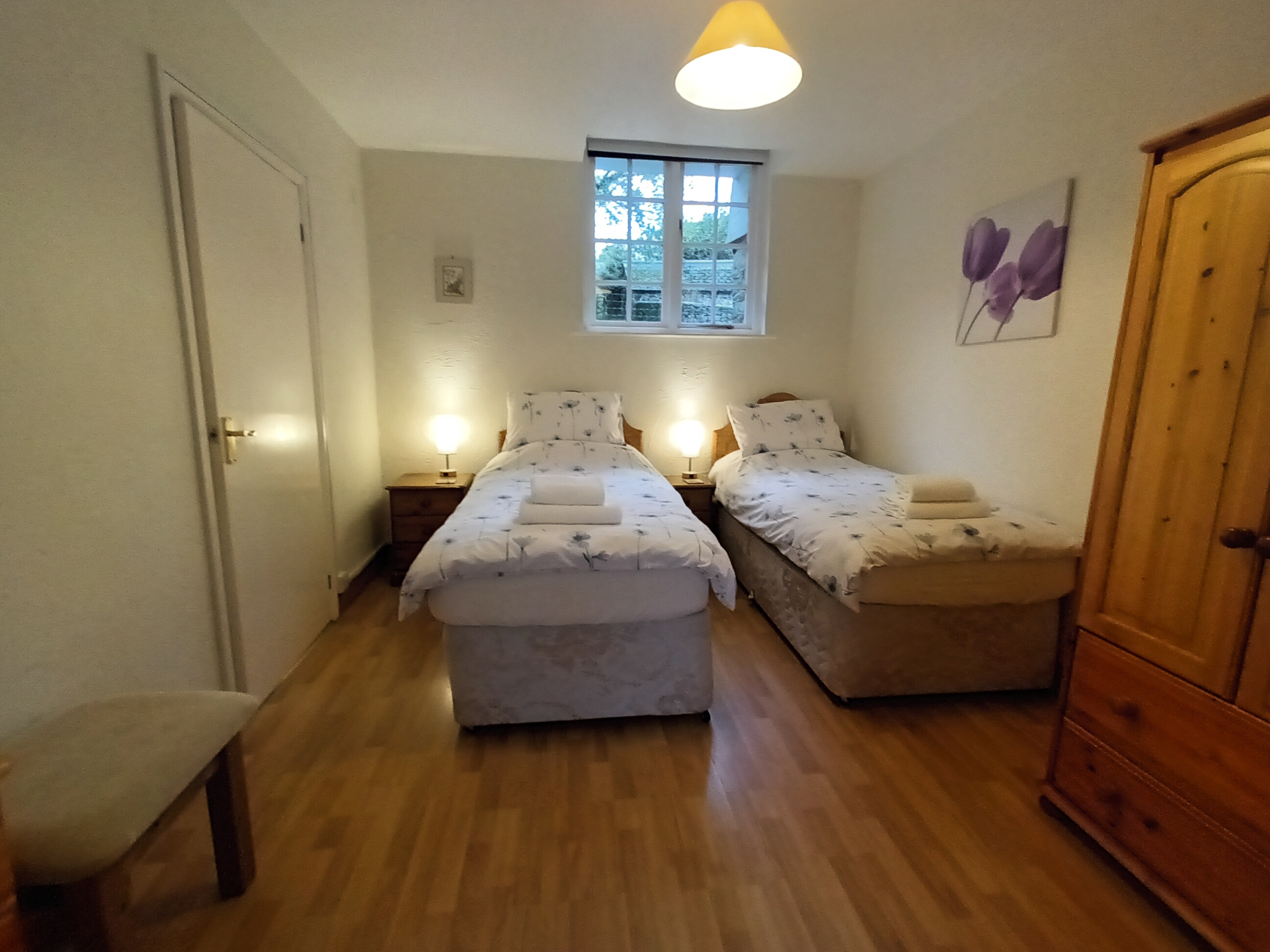 This ground floor bedroom has two full size single beds and an en suite