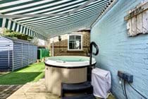 The Old Chapel Hot tub with canopy extended for shade.