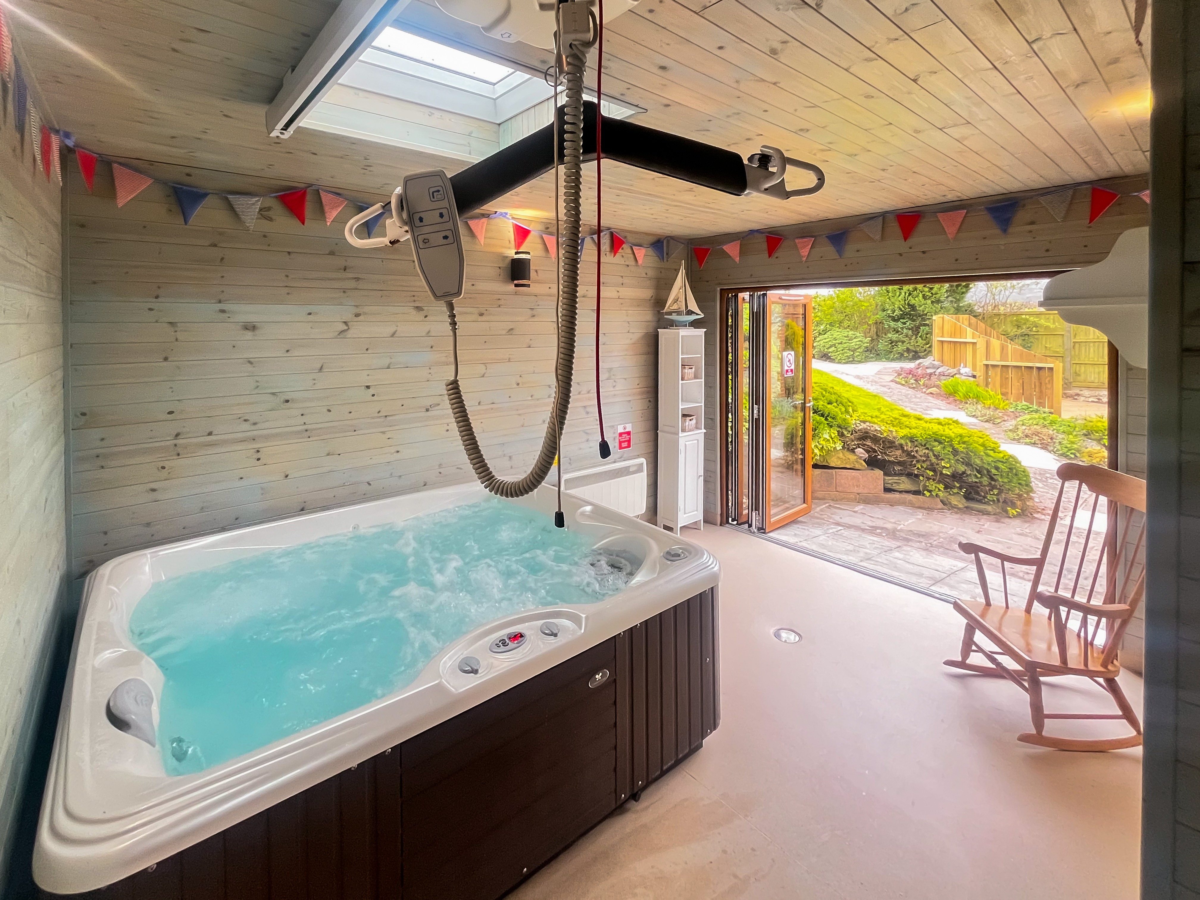 Hot tub with ceiling hoist