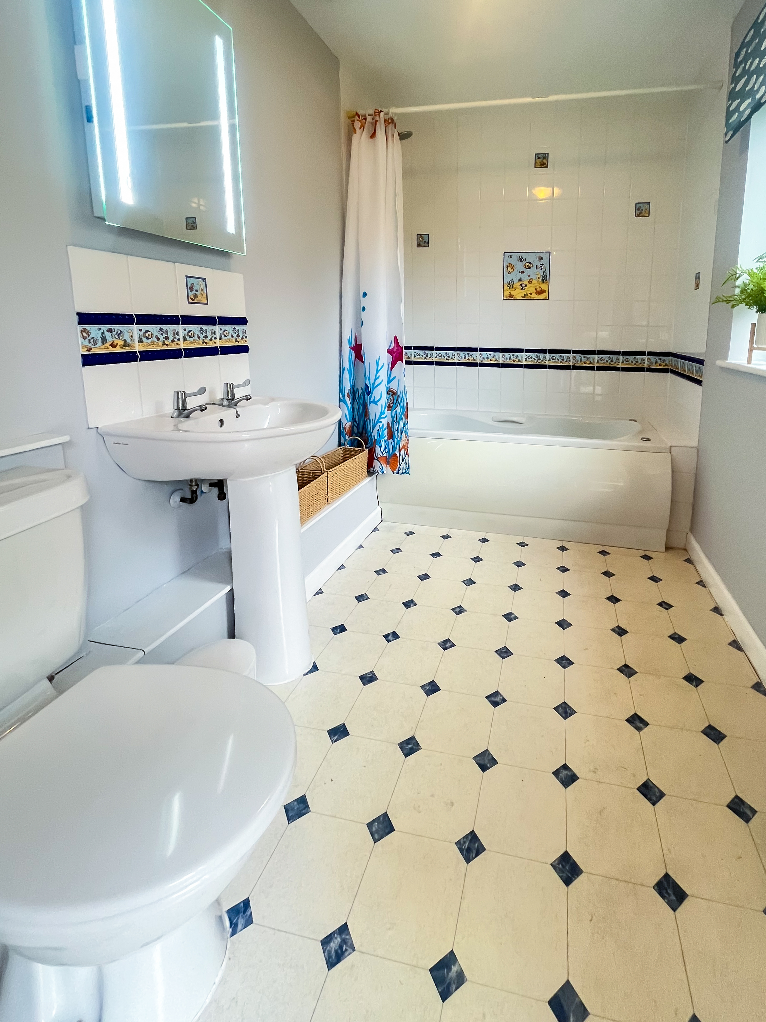 bathroom with whirlpool bath and shower over