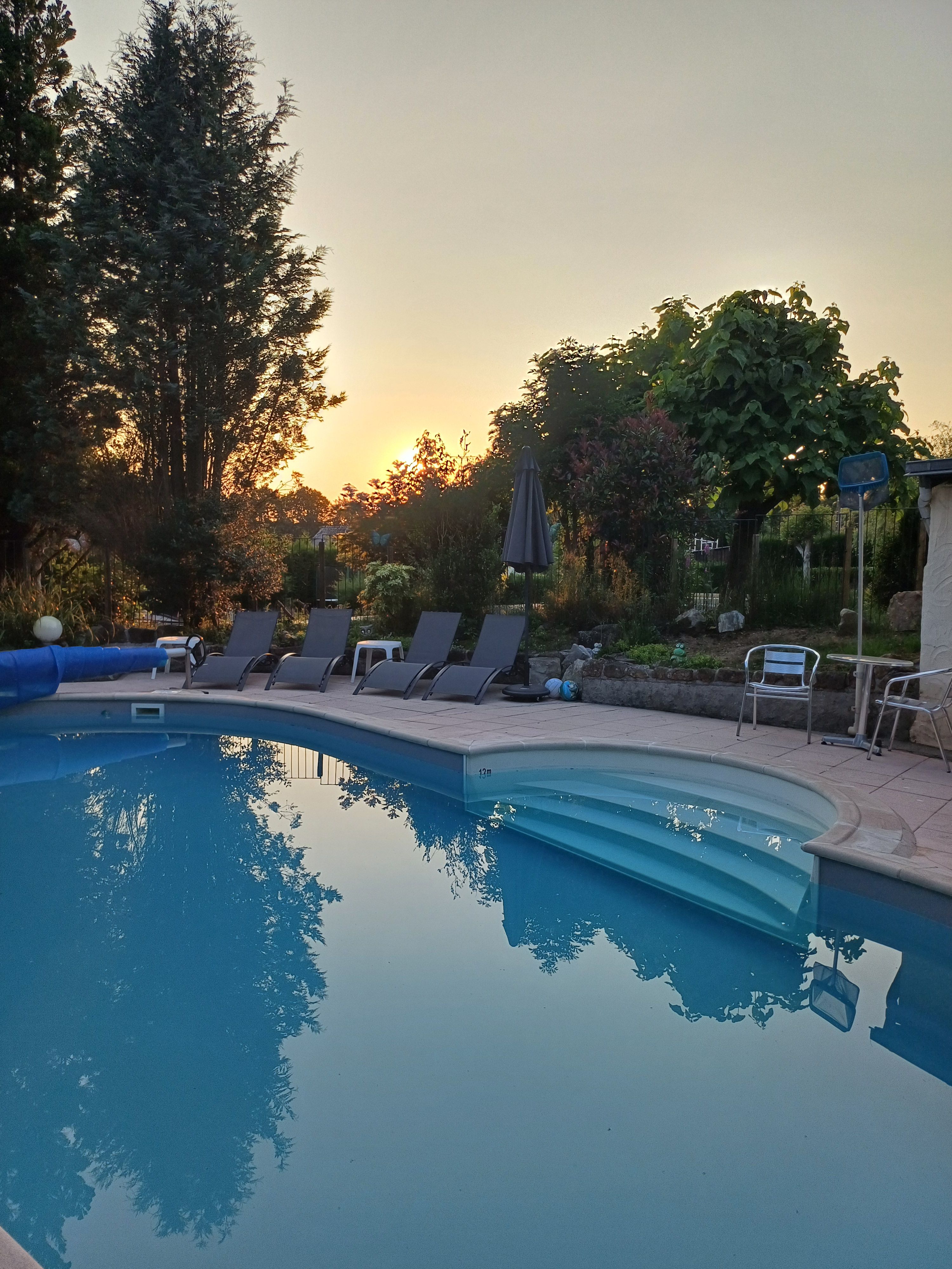Heated inground pool at sunset