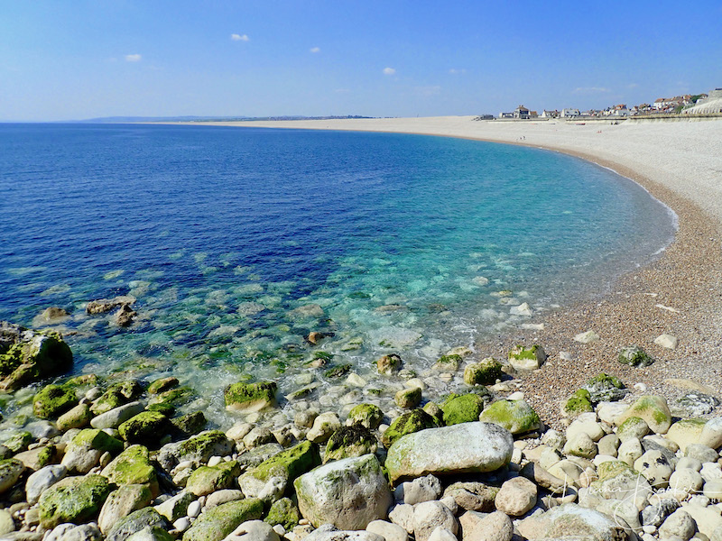 Chesil Beach, one of Dorset’s most iconic landmarks, offers miles of shingle coastline, ideal for beachcombing, birdwatching, and panoramic sea views.