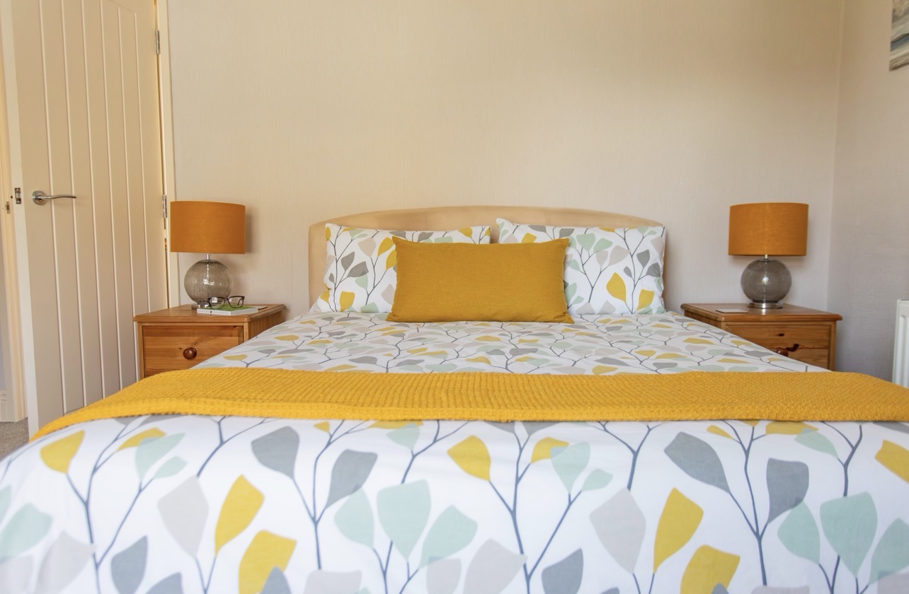 Spacious king bedroom with double bed, bedside tables and wardrobe