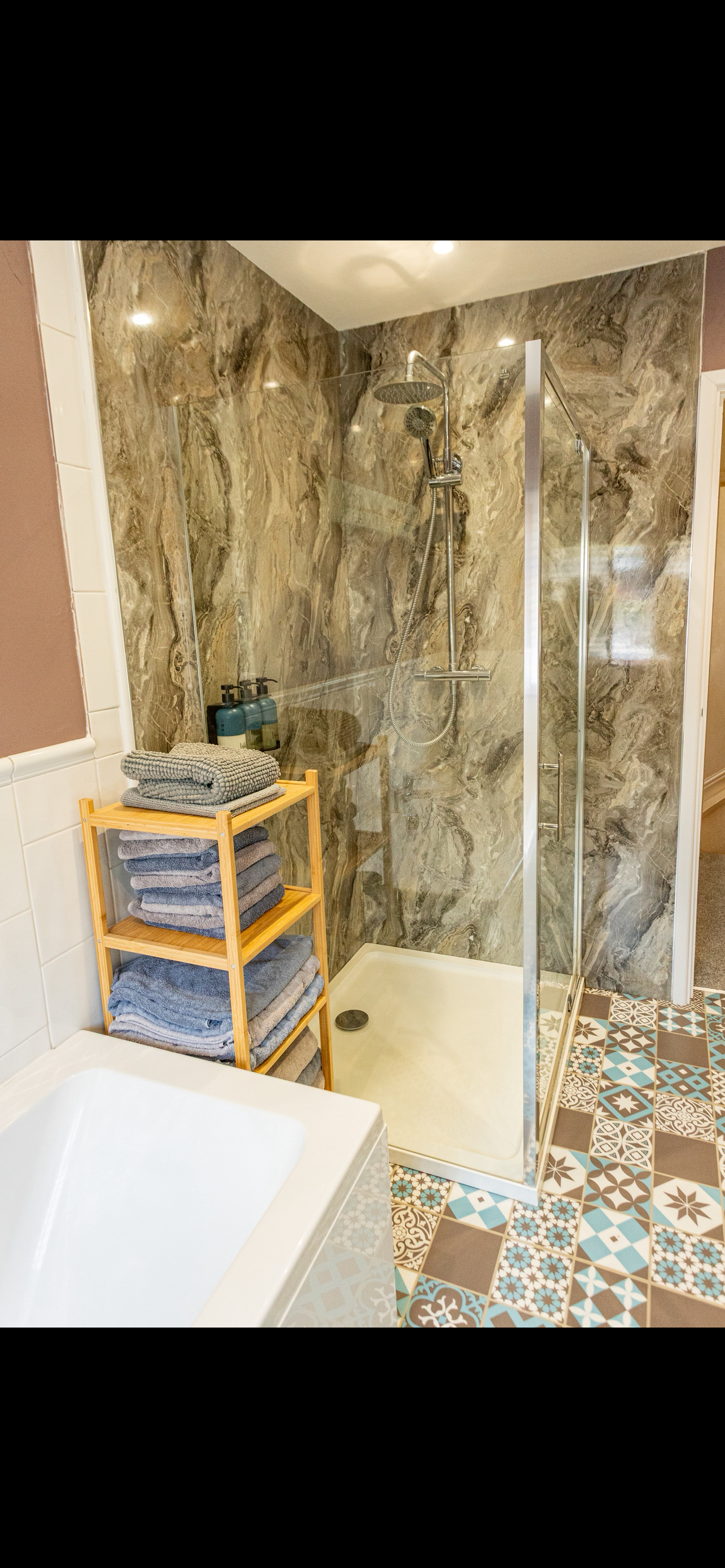 Modern bathroom with walk-in rain shower and separate bath in Portland holiday home