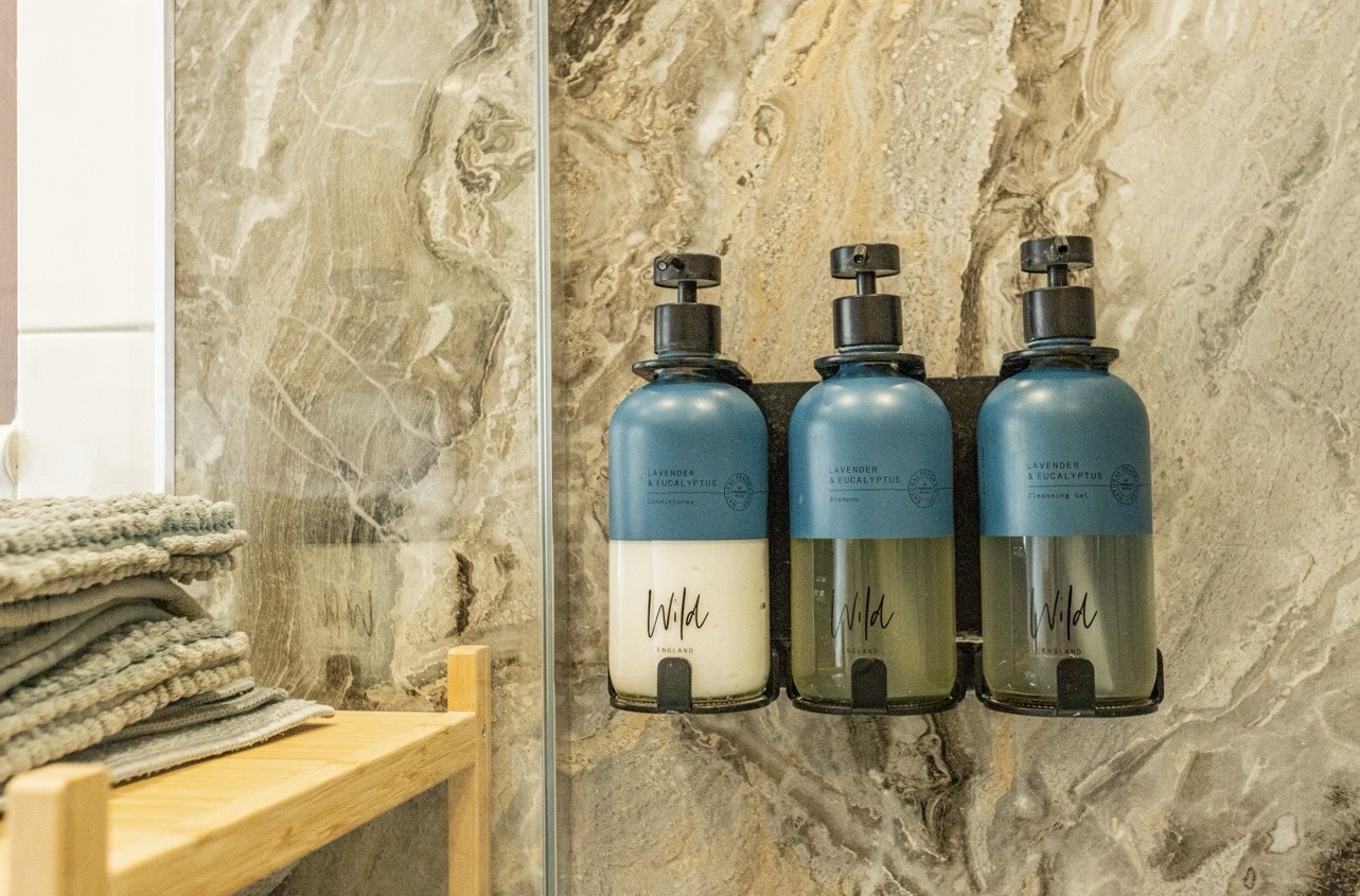 Eco-friendly refillable toiletries provided in walk-in shower at our Portland holiday cottage