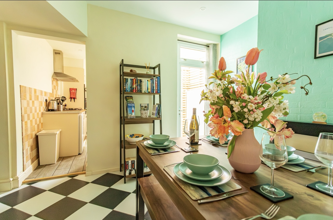 Victorian dining space flowing into the fully equipped kitchen with garden access, perfect for family meals.