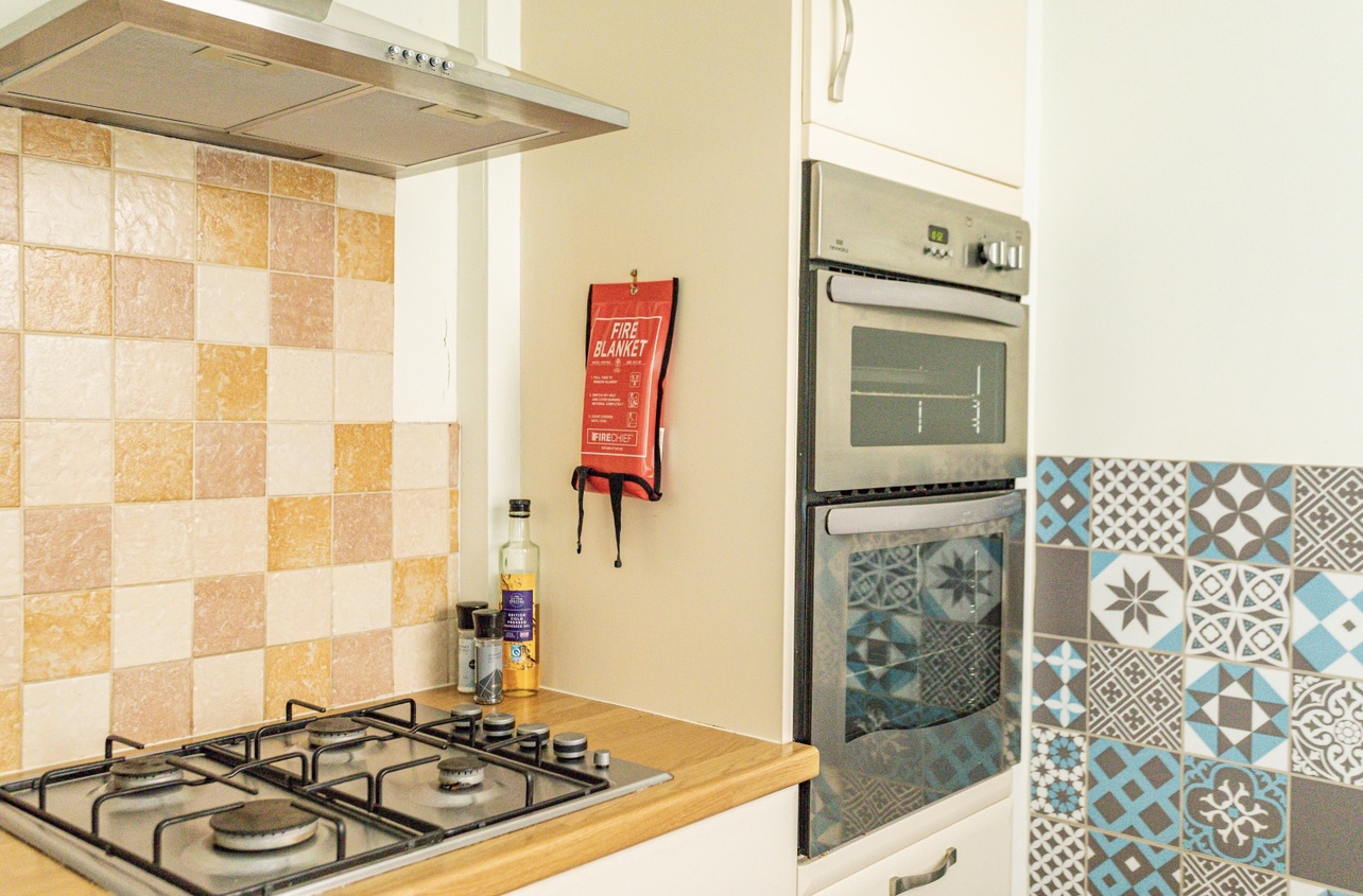 Fully equipped kitchen with modern appliances in Portland self-catering cottage.