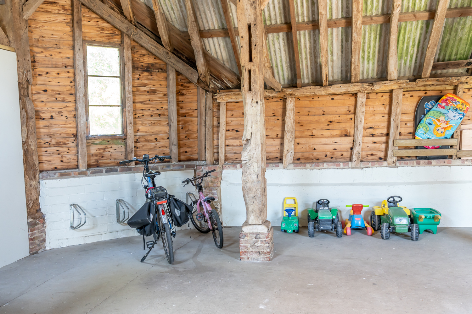 Interior of the Canute Cottages playbarn featuring a table tennis table, table football, and a small skittle alley for guests
