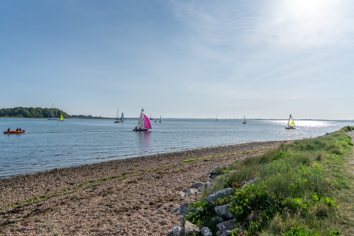 Sailing boat on the Cobnor Channel, part of Chichester Harbour, with calm waters and scenic surroundings
