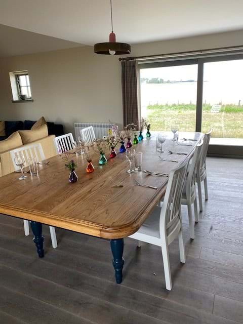 Dining table and the sliding doors in the NE gable with a view of the lighthouse