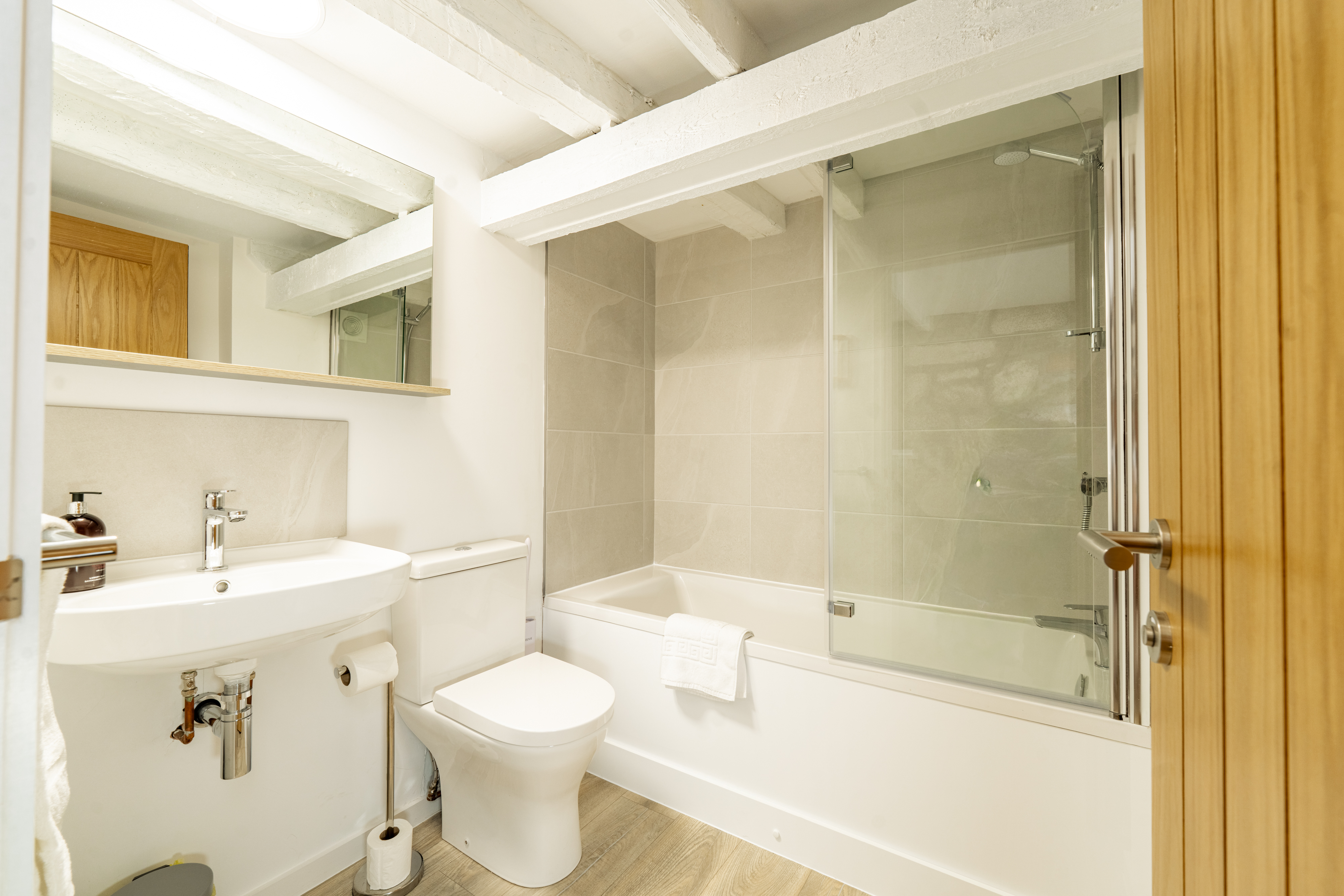 The bathroom has a powerful shower over the bath.