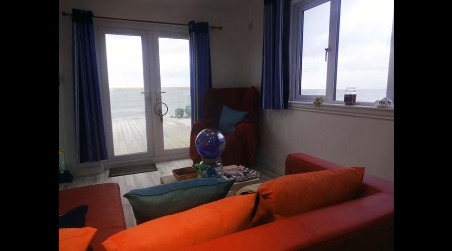 cabin with double bed, sofa area, TV and large shower room. Ideal for a restful escape. Seaview from every window