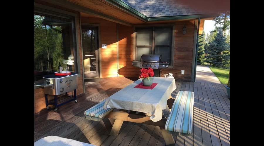 Large deck with cold drink cart, gas grill and seating for 12
