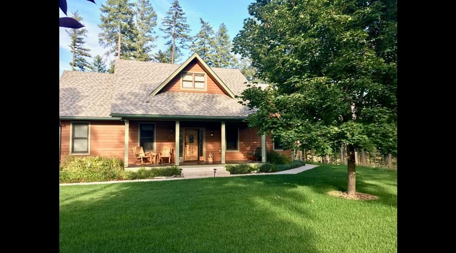 Lush front lawn and large shade trees