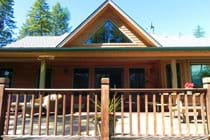 Back of house with deck facing the lake