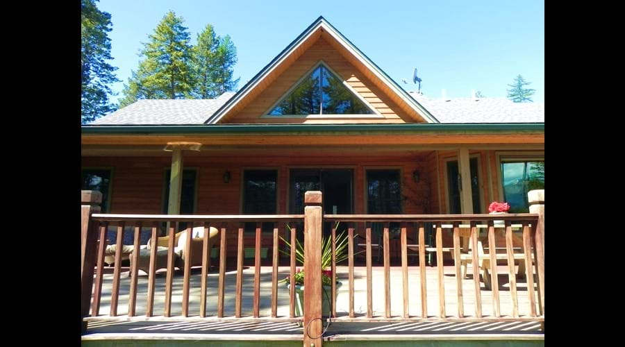 Back of house with deck facing the lake