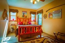 "Hollywood Cowboy" bedroom with queen log bed