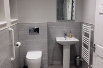 Groundfloor disabled friendly ensuite wetroom with wall hung WC, basin and illuminated mirror