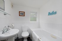 Bathroom across hallway from First Floor Twin room with full size bath with mixer tap, washbasin and wc