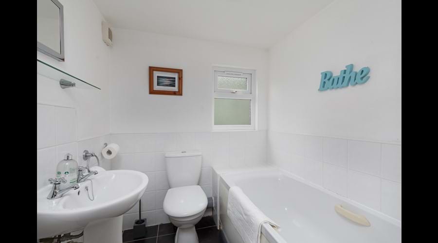 Bathroom across hallway from First Floor Twin room with full size bath with mixer tap, washbasin and wc
