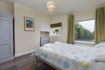 Groundfloor large Double Bedroom with king size bed, wardrobe, chest of drawers, bedside tables and ensuite wetroom