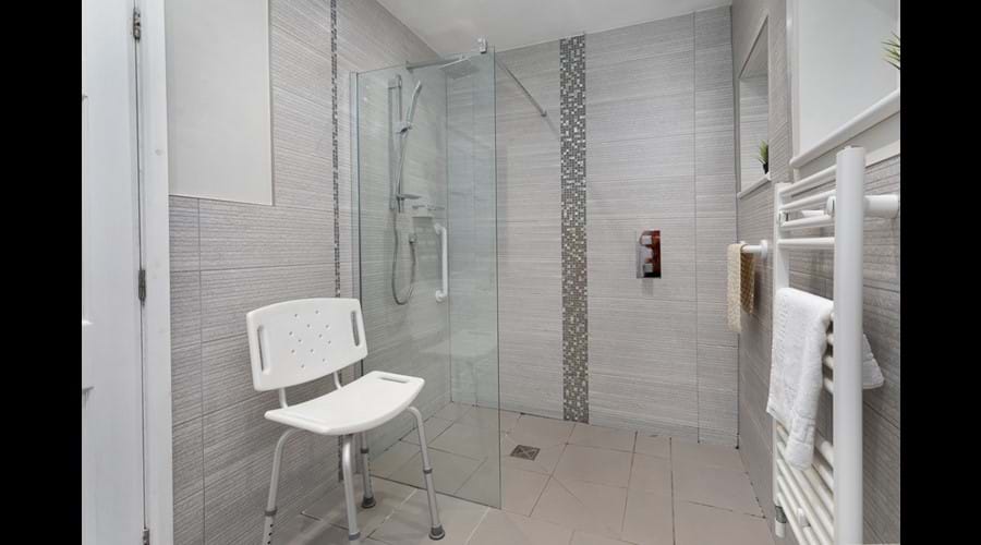 Ensuite wetroom to groundfloor large double room with large shower enclosure, shower chair and extra grab rail