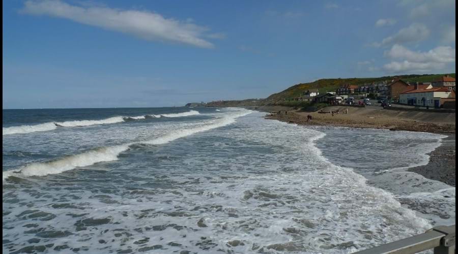 View towards Whitby from Sandsend as tide comes in