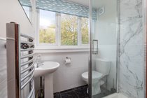 Ensuite shower room to twin room accessed from kitchen with shower, wc, washbasin