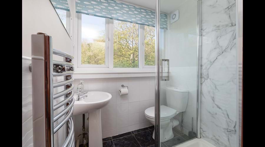 Ensuite shower room to twin room accessed from kitchen with shower, wc, washbasin