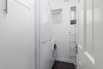 Utility Room off hall with fridge/freezer, washer/dryer, ironing board/iron