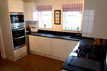 Newly fitted kitchen with fitted double oven, microwave, gas hob, dishwasher and fridge